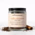 Jar of selflovessence coffee cinnamon body scrub with a cinnamon stick on a white background